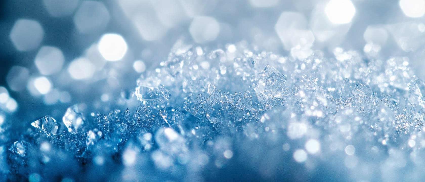 Extreme close-up of pale crystalline material, light scattering through it